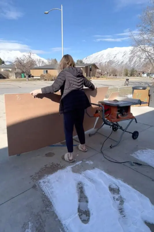 Using a table saw to cut plywood.